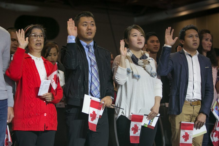 VANCOUVER, CANADA - JULY 1:  Sixty new citizens from 26 countries swear their allegiance to their new nation during a special Canada Day ceremony on July 1, 2016 in Vancouver, British Columbia, Canada.  Vancouver, the largest city in the province, celebrates the country's 149th Canada Day with music, food, a parade, and fireworks in and around Canada Place, the waterfront convention centre. (Photo by George Rose/Getty Images)